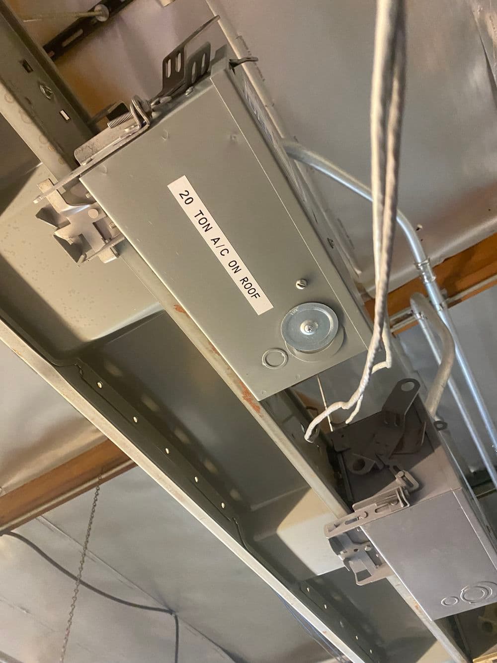 20-ton AC unit mounted on roof with visible wiring and structural supports.