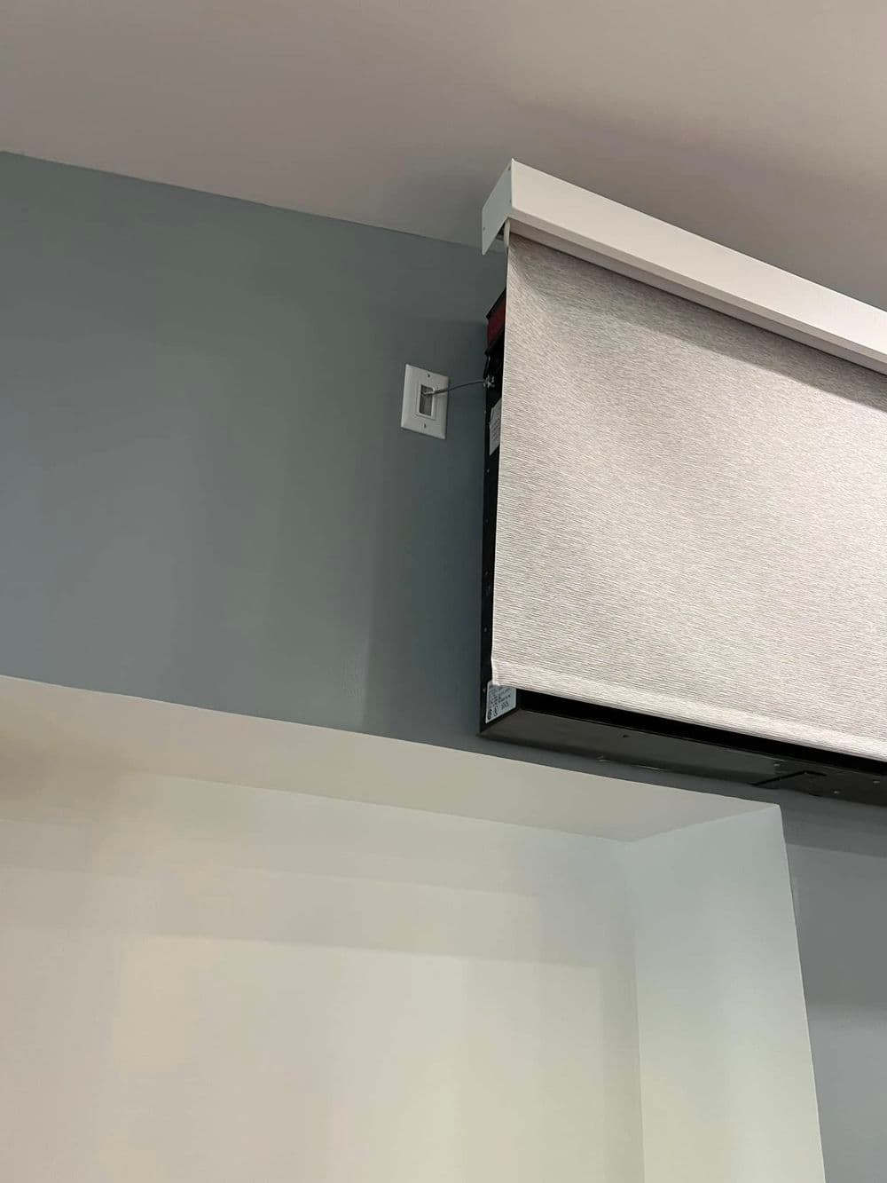 Roller shade installed on a gray wall, showcasing modern home decor.